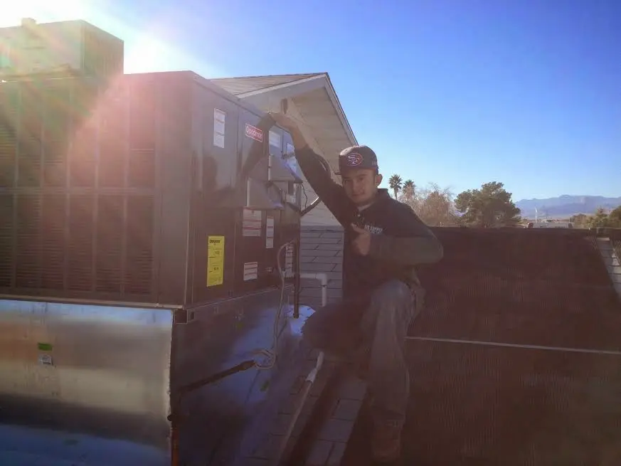 HVAC technician performing AC Tune-Up on a rooftop unit in Bay Point